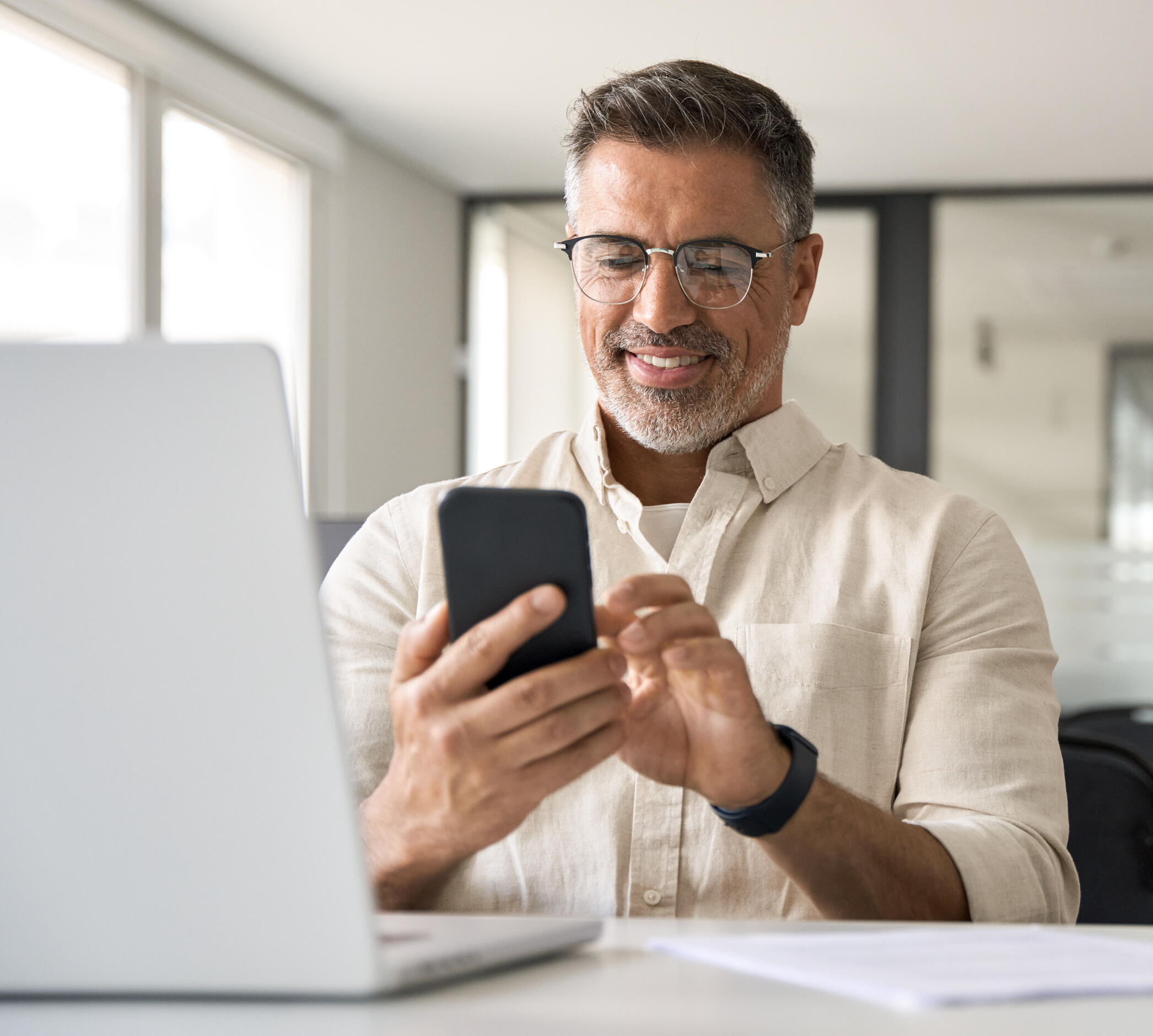 Local service provider happily looking at his phone after receiving leads through seo initiatives